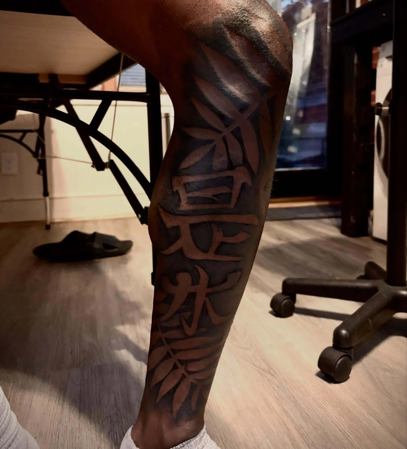 Black and grey calf sleeve with kanji characters and bamboo leaves by Creative Tat at Shadow Studio Charlotte