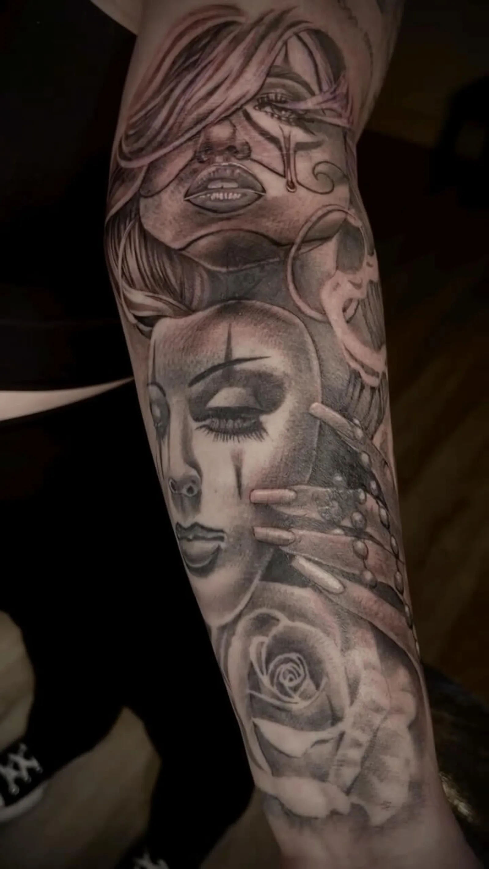 Black and grey Chicano-style forearm sleeve of a clown girl with rose by Creative Tat at Shadow Studio Charlotte