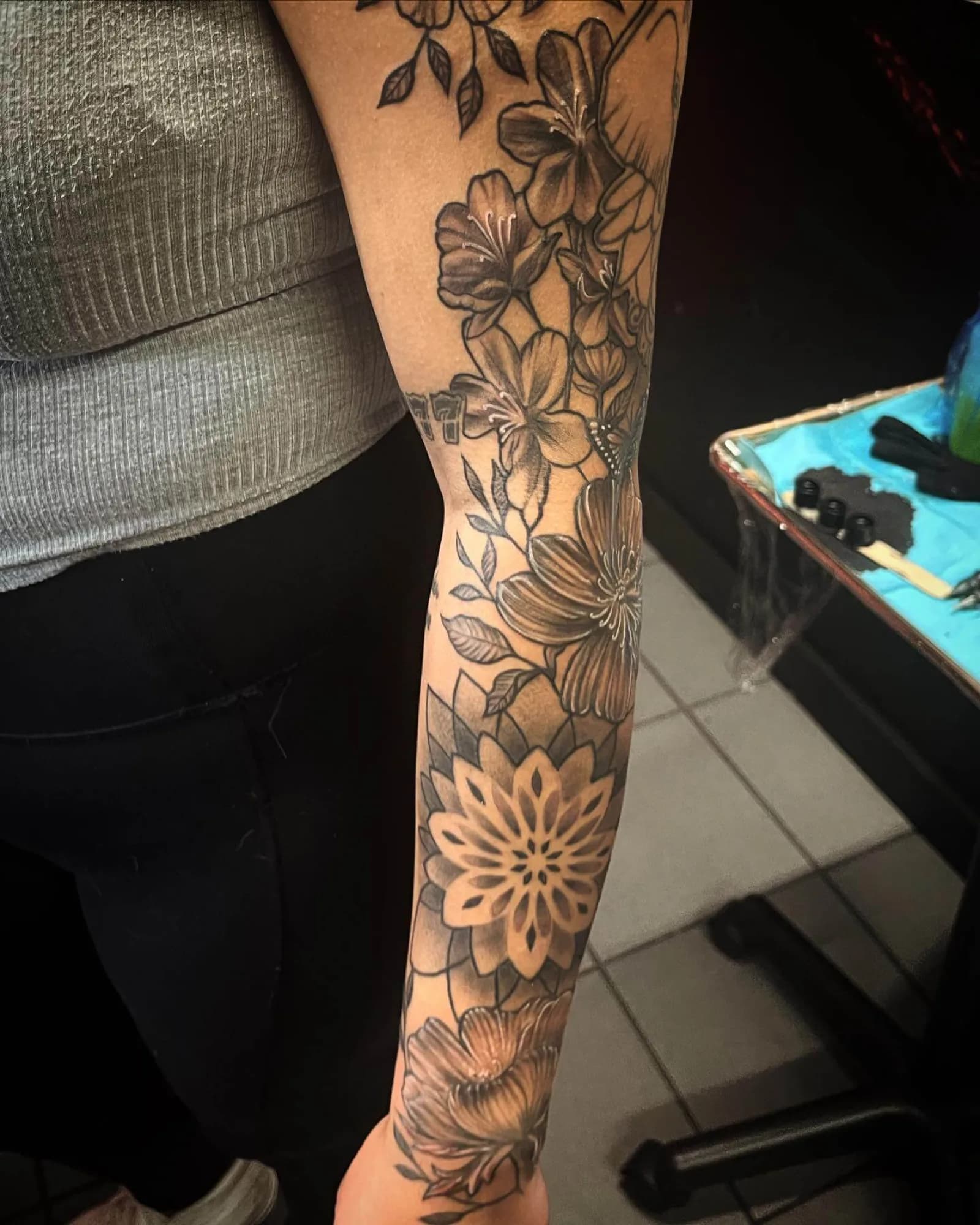 Black and grey full-sleeve floral piece with mandala and mixed blossoms by Creative Tat at Shadow Studio Charlotte
