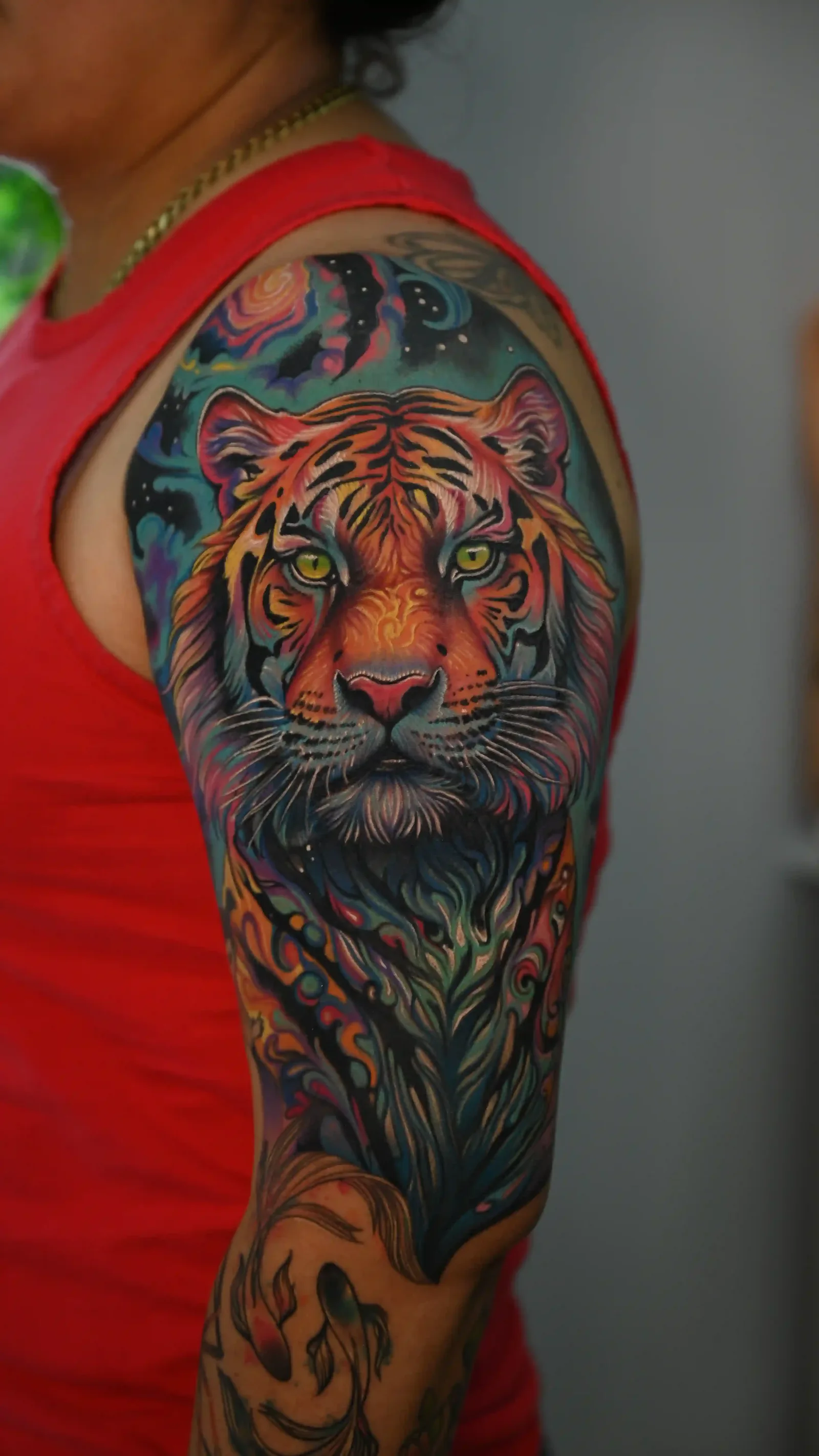 Vibrant color realism tiger upper-arm sleeve with cosmic accents by Danyi at Shadow Studio Charlotte