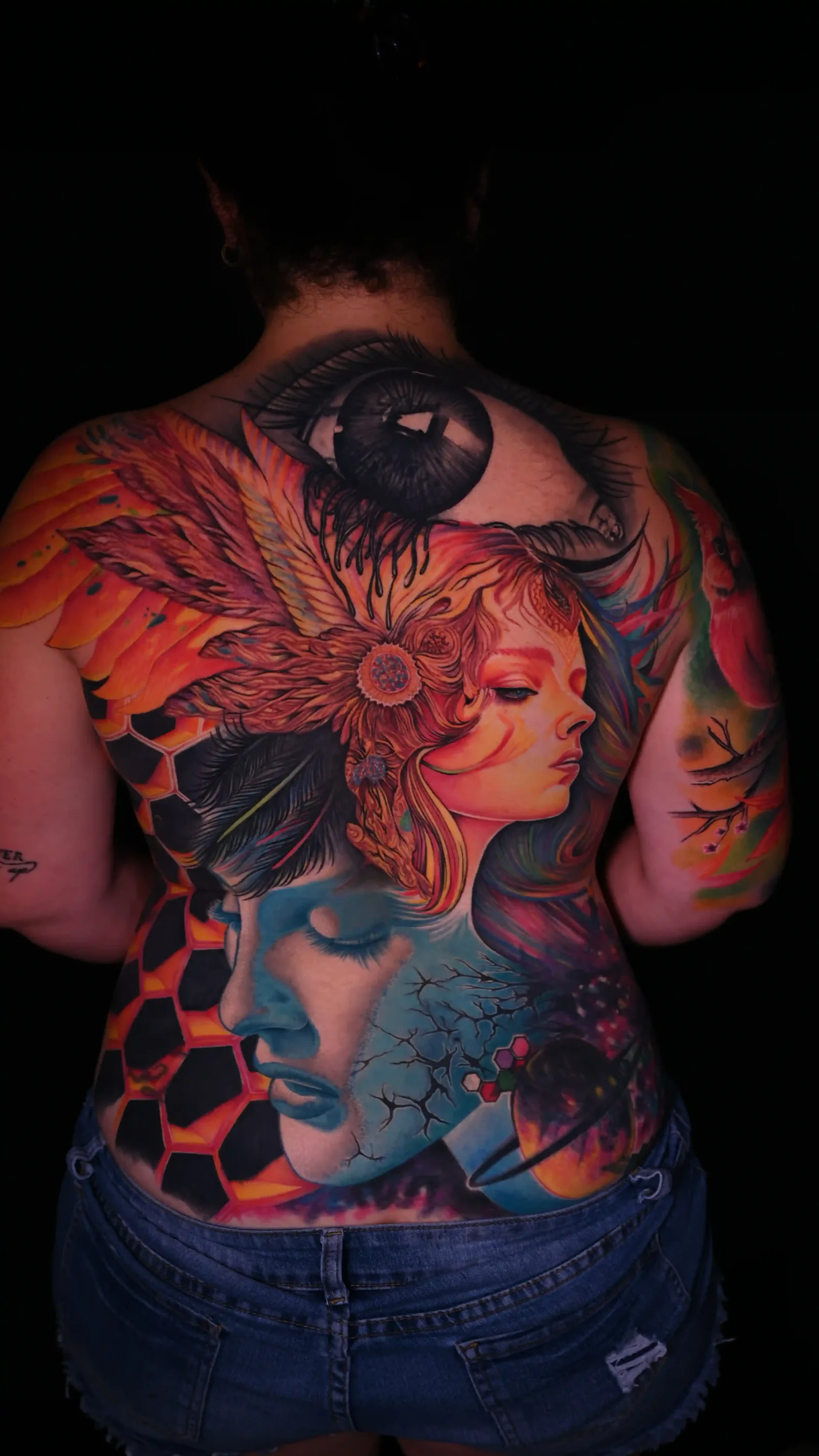 Vibrant color realism back piece featuring a phoenix, woman's portrait, and hexagonal mosaic by Danyi at Shadow Studio Charlotte