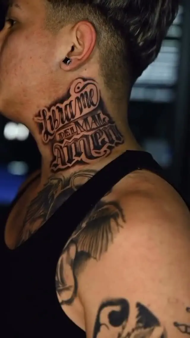Black and grey ornate-script lettering tattoo on the side of the neck by El Michael at Shadow Studio Charlotte
